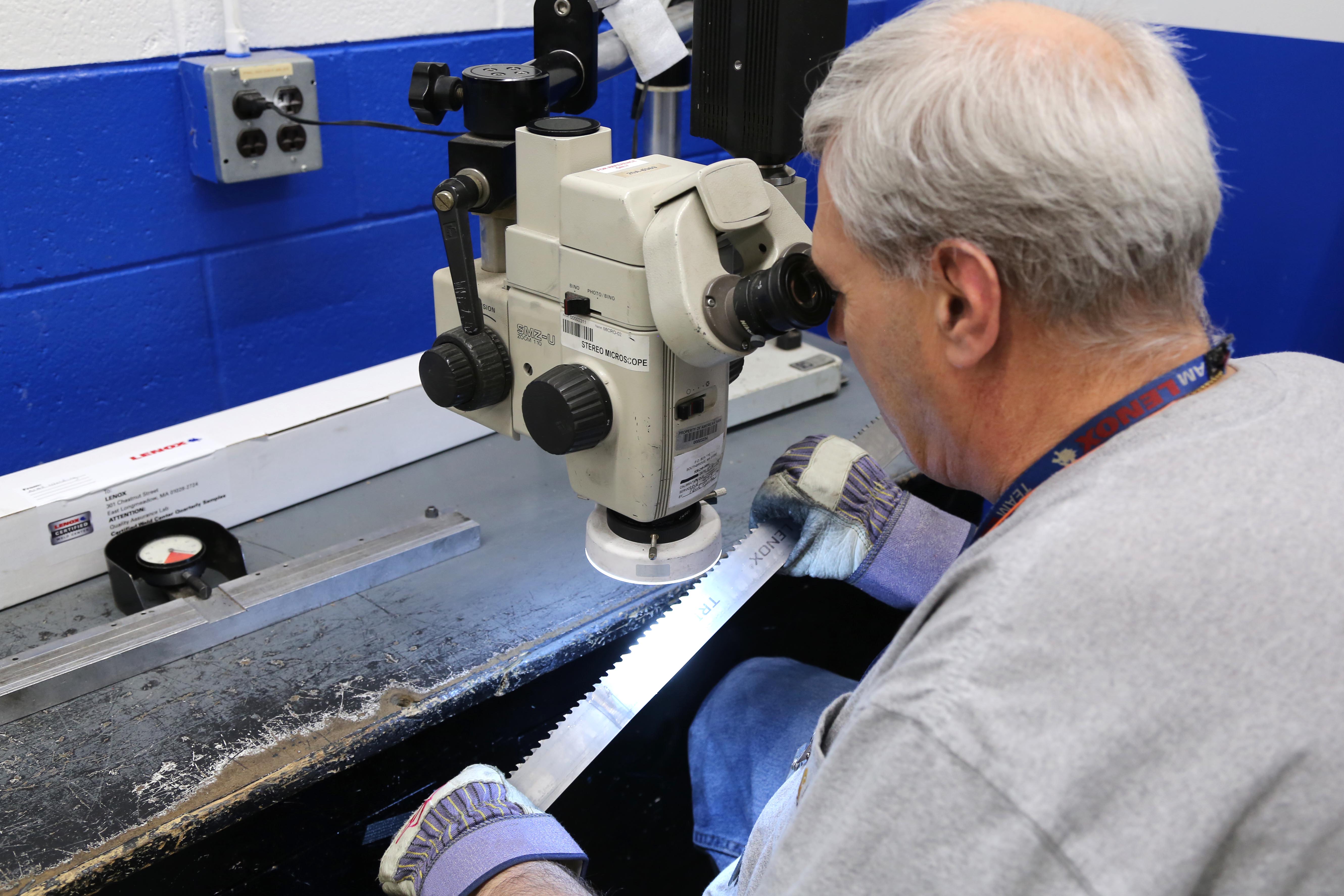 A QA technician inspects a blade at the Lenox Quality Assurance Lab.